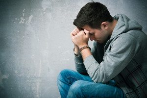 young juvenile boy minor in handcuffs under arrest