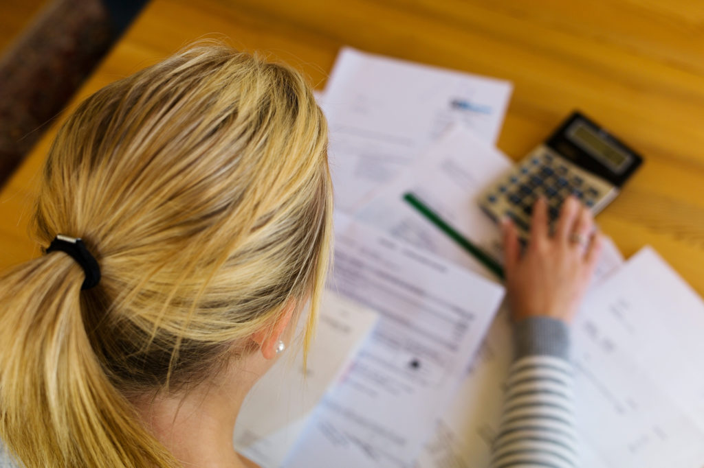 woman calculating financial paperwork