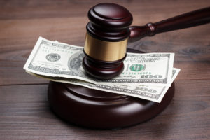 gavel and money on wooden table