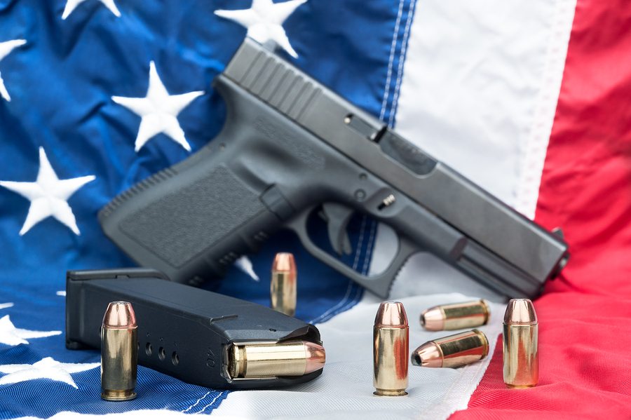 unloaded gun and cartridge with bullets sit on American Flag unloaded gun and cartridge with bullets sit on American Flag