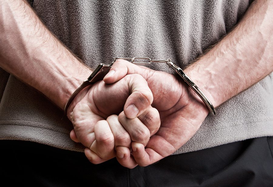 closeup on man in handcuffs